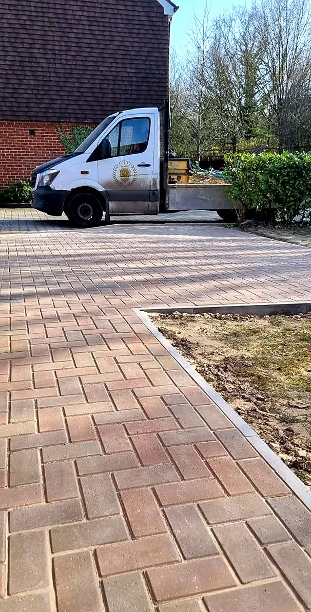 Close-up of a block paved driveway with a Bonwycks van on site