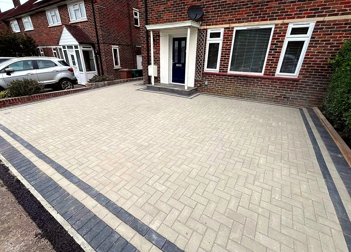 Cream block paved driveway with a charcoal border outside a home
